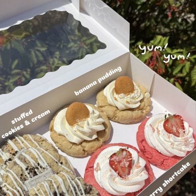 Box of strawberry shortcake and banana pudding cupcakes with stuffed cookies